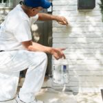 Professional painting contractor painting brick exterior