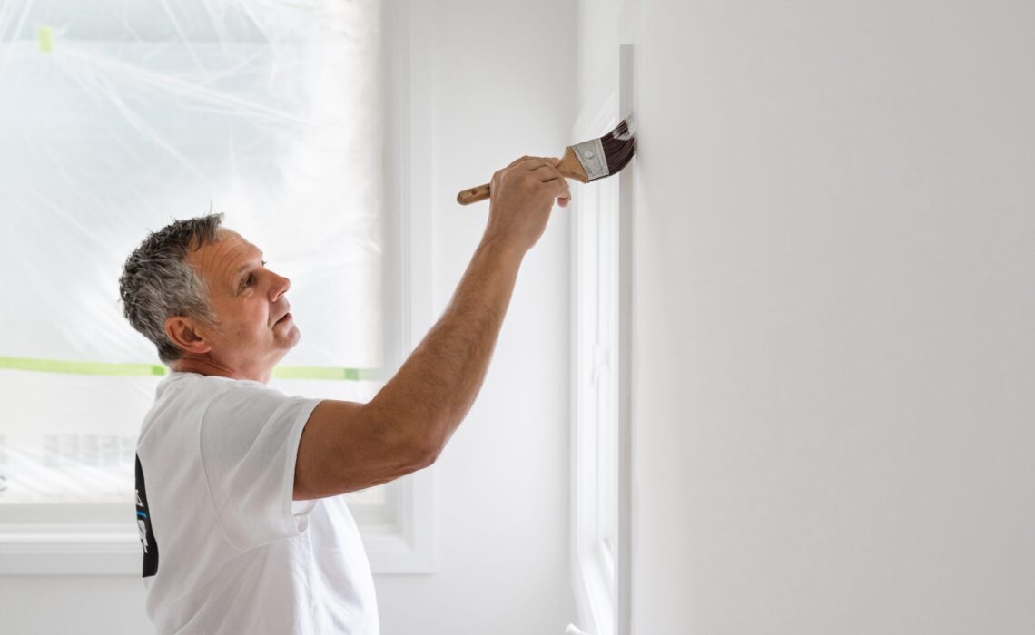 Pro painting interior room with brush