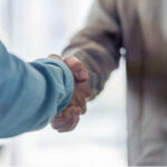 Stock photo of two people shaking hands