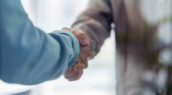 Stock photo of two people shaking hands