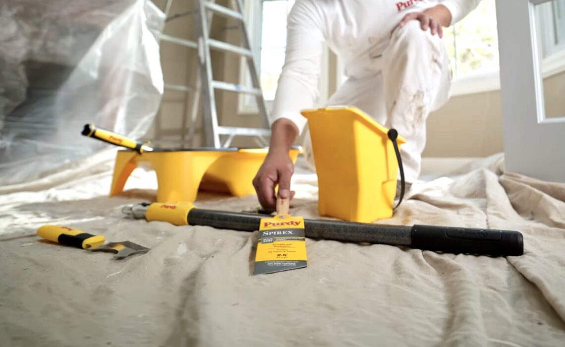 Photo of contractor with Purdy Spirex brush and other equipment on job site